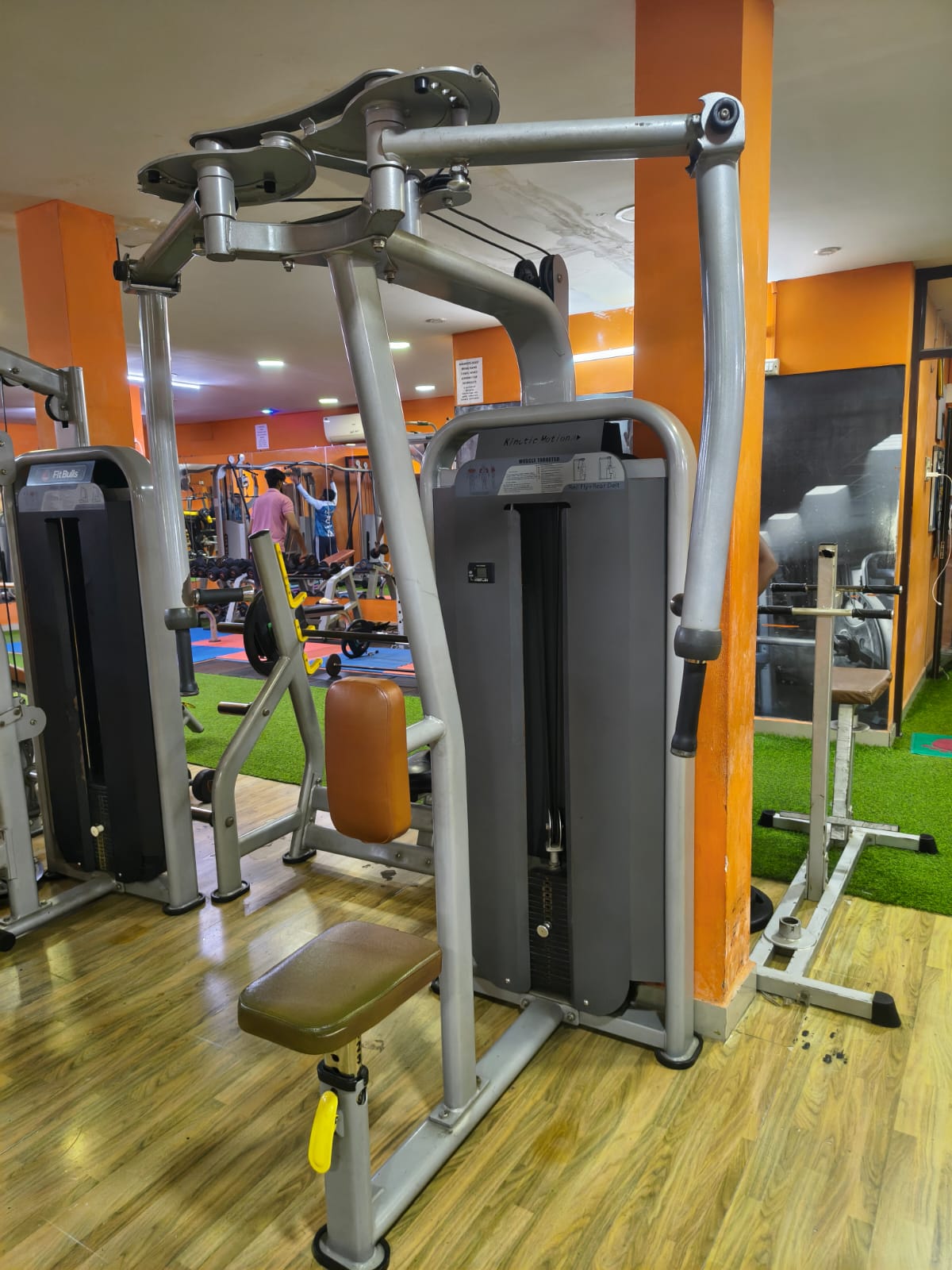 Pec fly and rear delt machine with selectorized machines and a dumbbell area behind