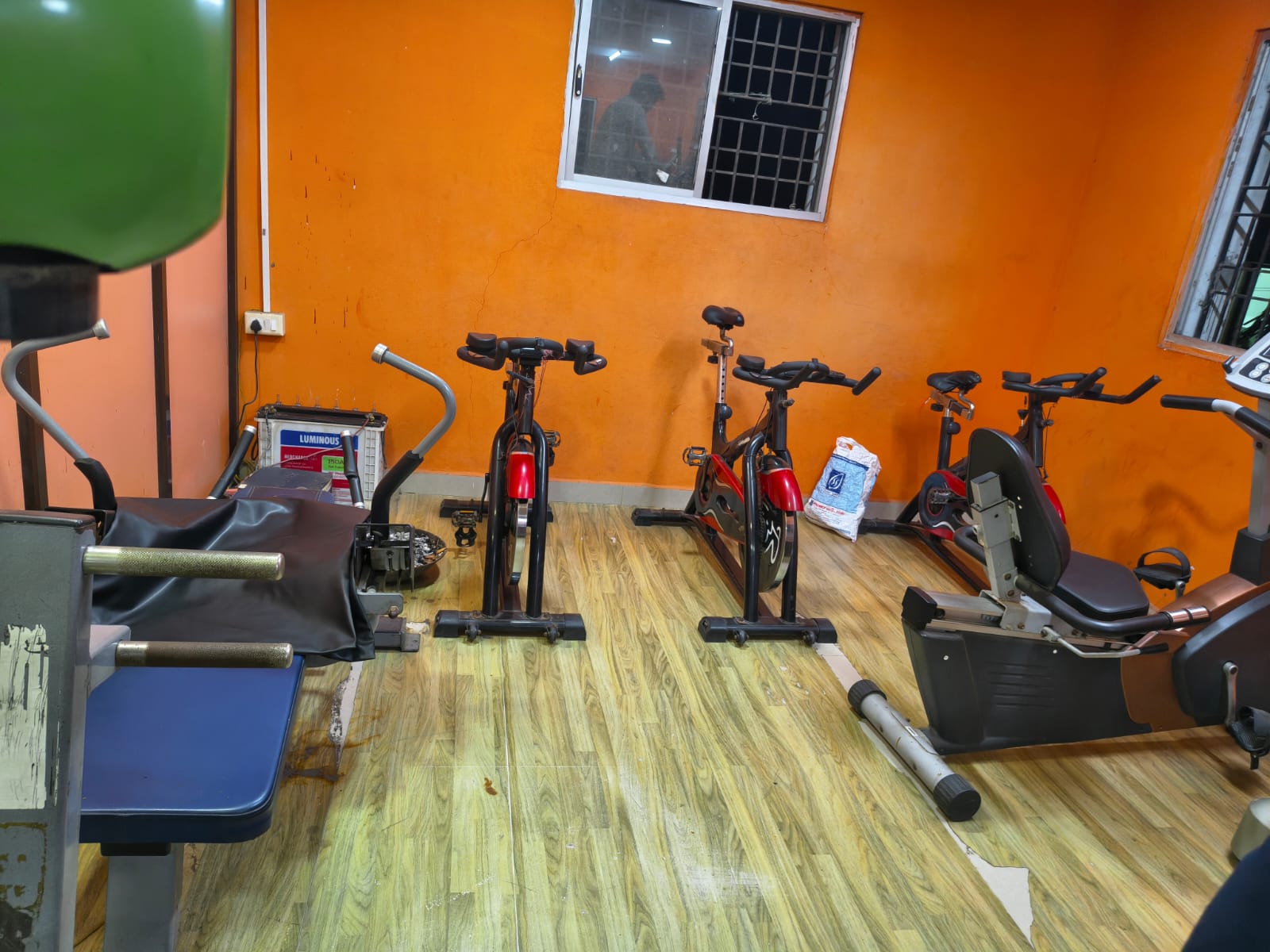 Three spin bikes and a recumbent bike in the cardio section
