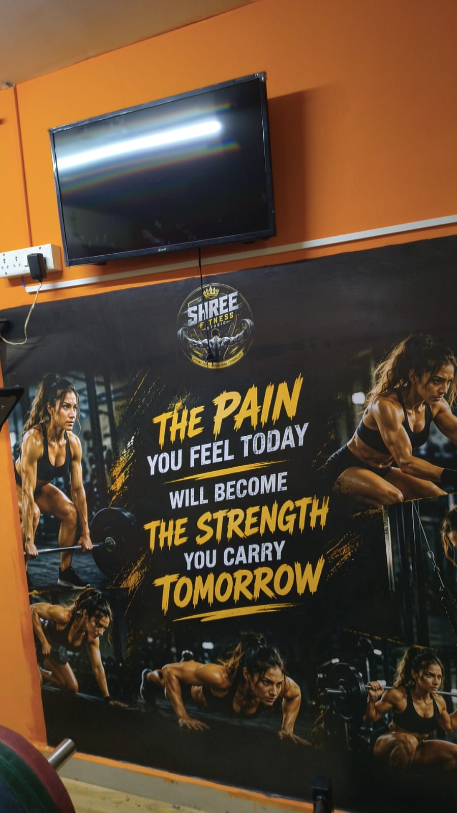 Mural of women training with the quote “The pain you feel today will become the strength you carry tomorrow”
